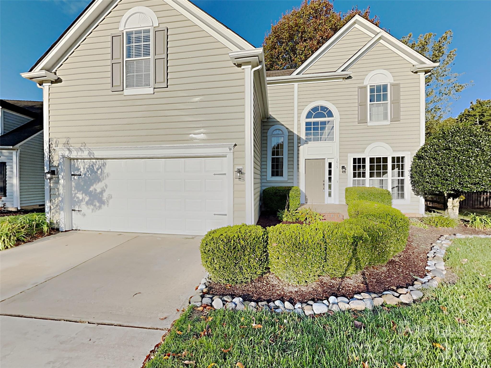 1015 Clearbrook Road Matthews, NC 28105 - Photo 1 of 25 a view of a white house with large windows