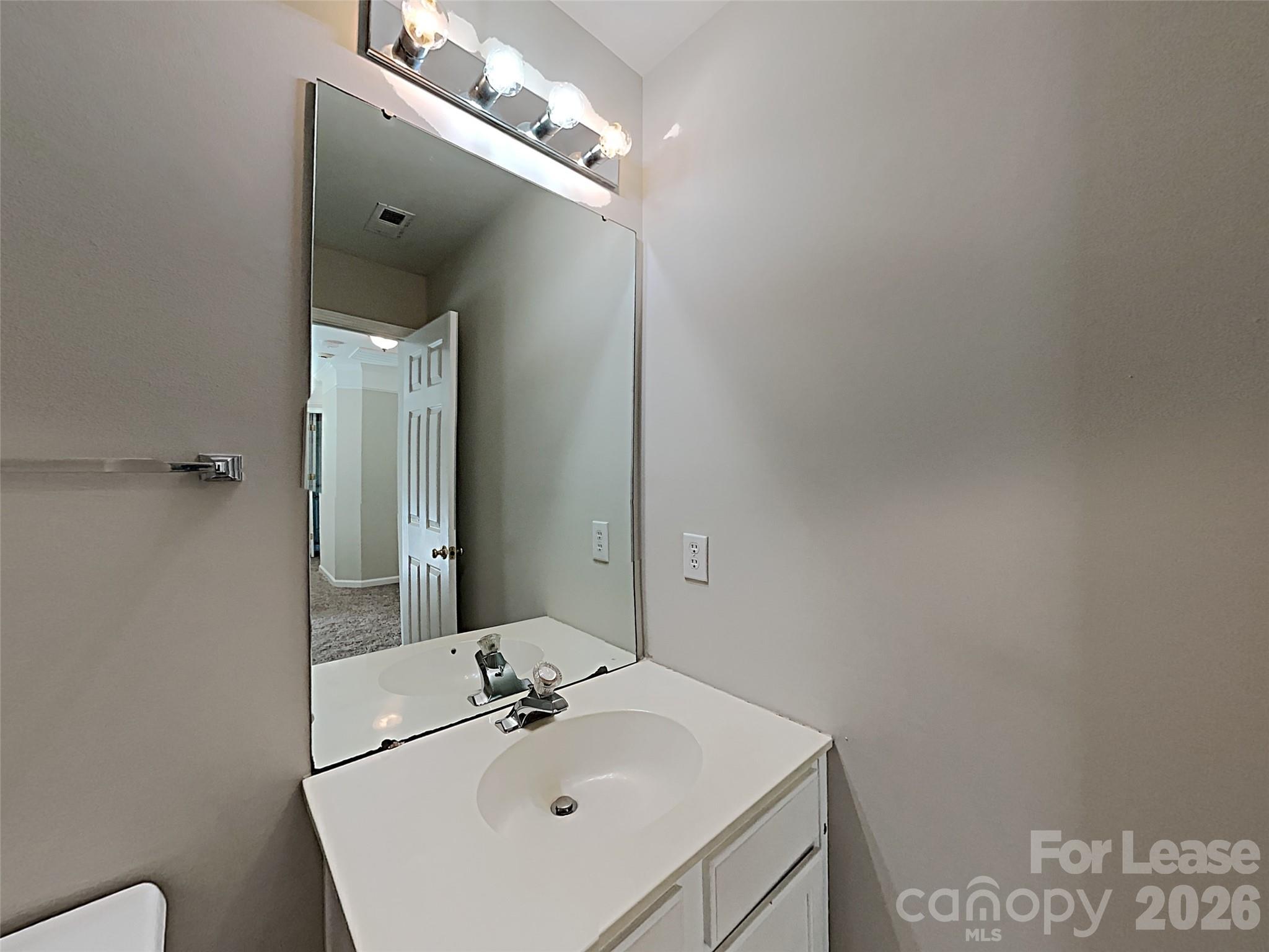 1015 Clearbrook Road Matthews, NC 28105 - Photo 19 of 25 a bathroom with a sink and a mirror