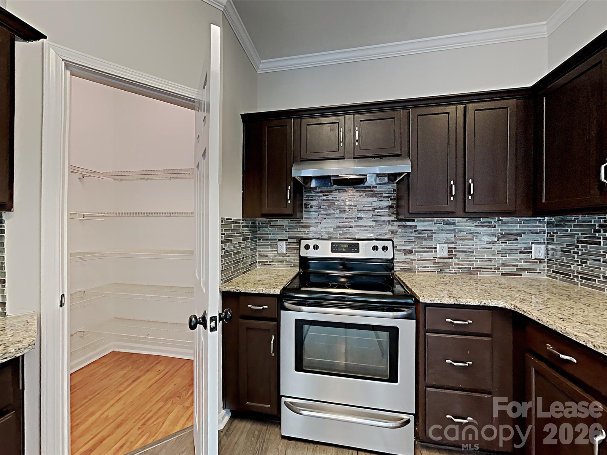 1015 Clearbrook Road Matthews, NC 28105 - Photo 4 of 25 a kitchen with a stove and a microwave