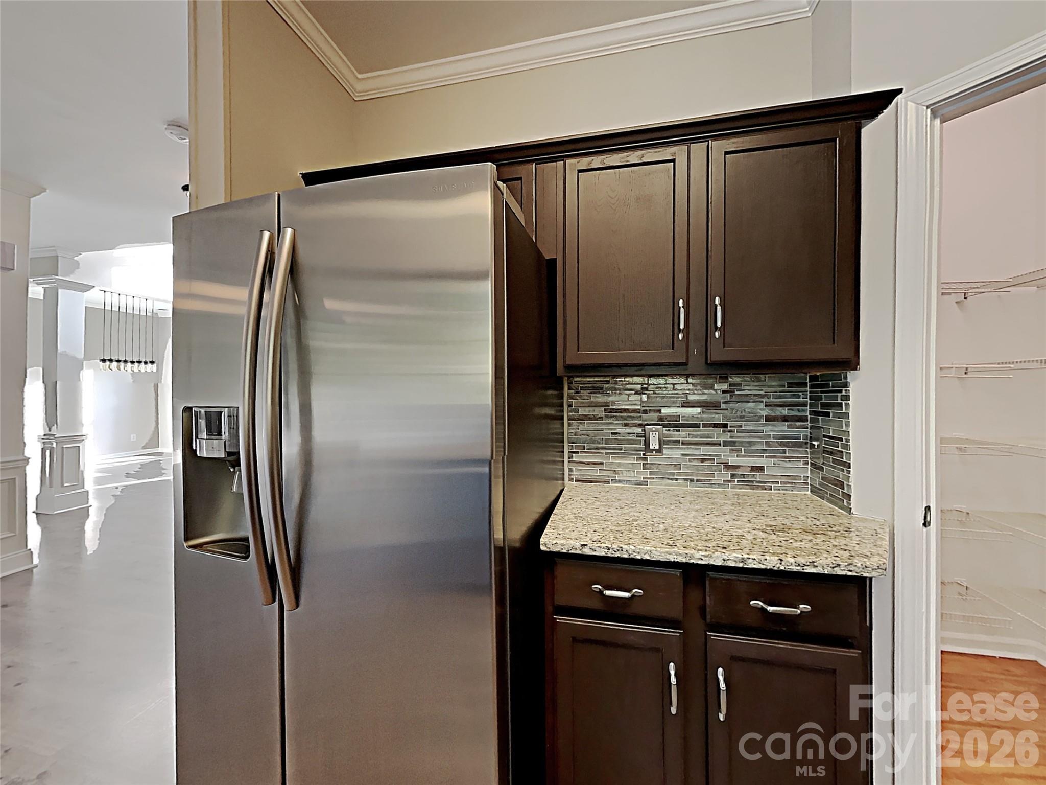1015 Clearbrook Road Matthews, NC 28105 - Photo 6 of 25 a kitchen with a refrigerator and cabinets