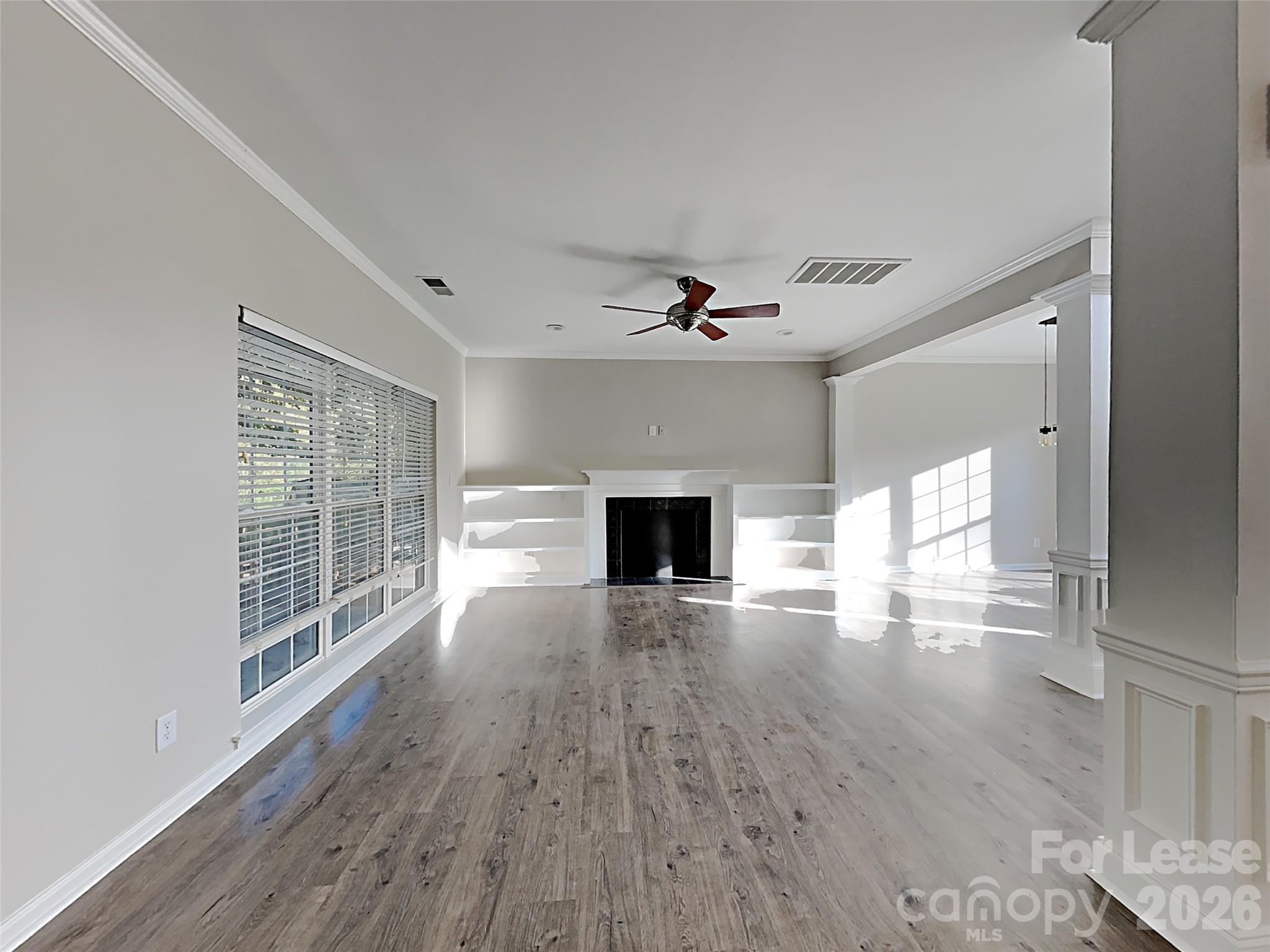 1015 Clearbrook Road Matthews, NC 28105 - Photo 7 of 25 a view of empty room with wooden floor and fireplace