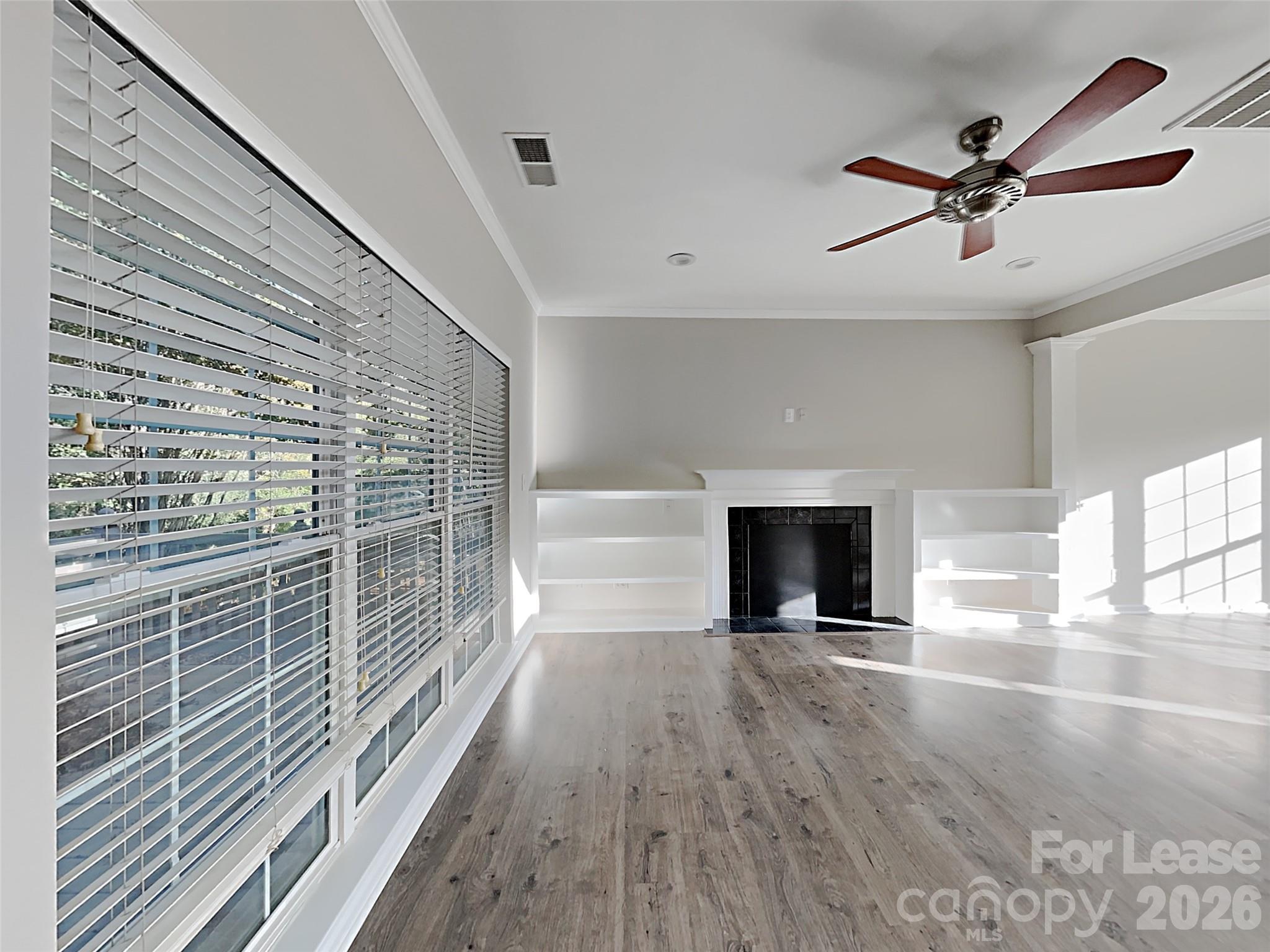 1015 Clearbrook Road Matthews, NC 28105 - Photo 8 of 25 a view of livingroom with wooden floor and a ceiling fan