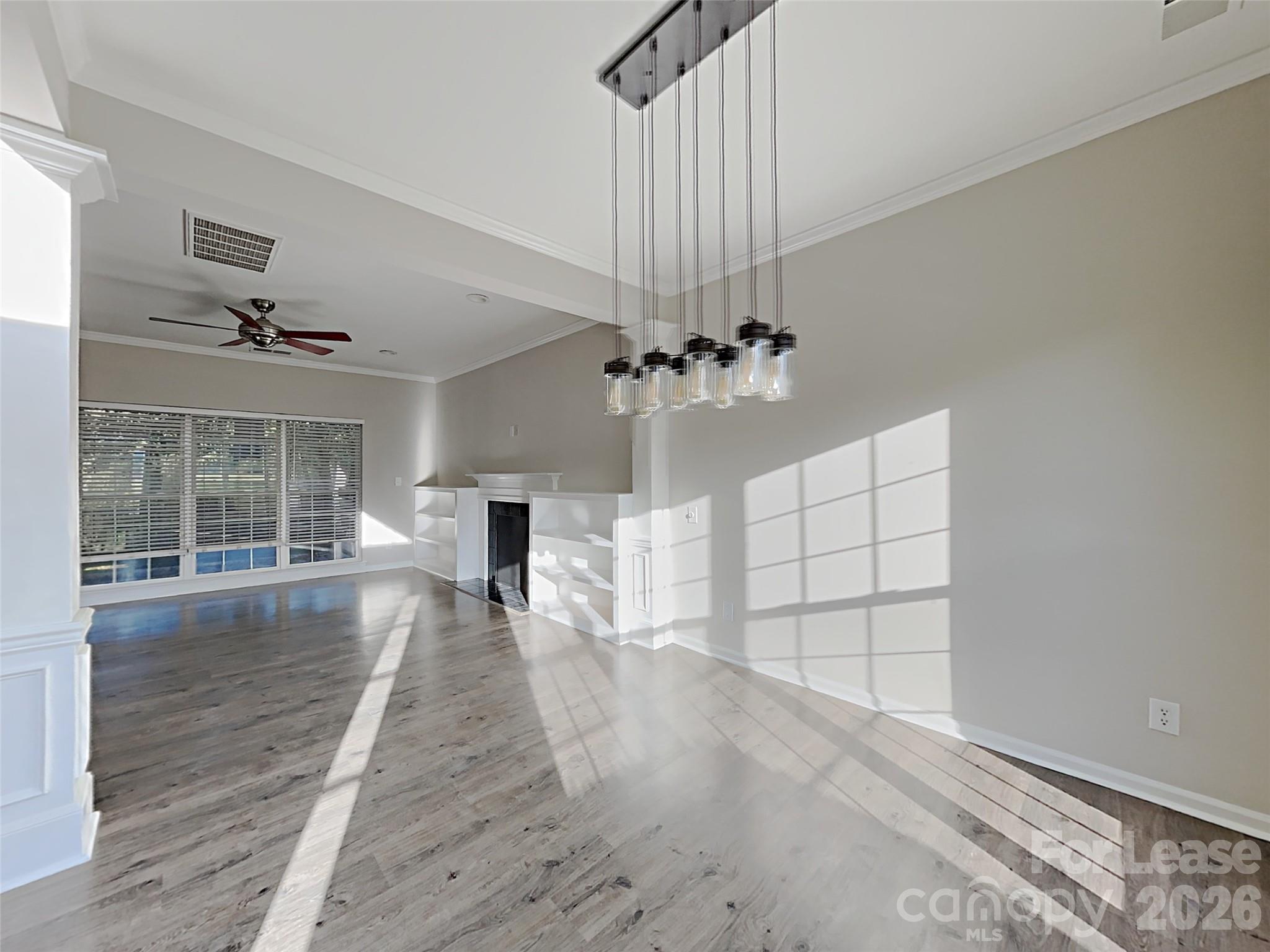 1015 Clearbrook Road Matthews, NC 28105 - Photo 9 of 25 a view of empty room with wooden floor and fan