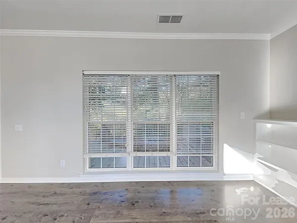 a view of wooden floor and window