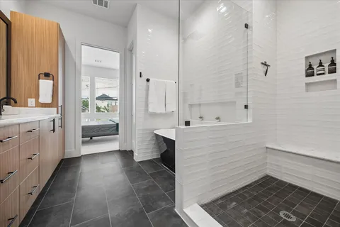 a bathroom with a double vanity sink a mirror and a bathtub