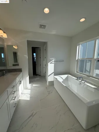a spacious bathroom with a double vanity sink and a mirror