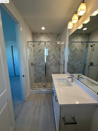 a bathroom with a sink a shower and a mirror