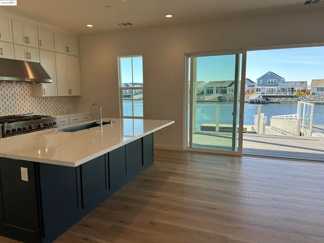 a kitchen with stainless steel appliances granite countertop a sink counter space and wooden floor