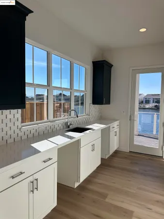 a kitchen with lot of counter space and windows