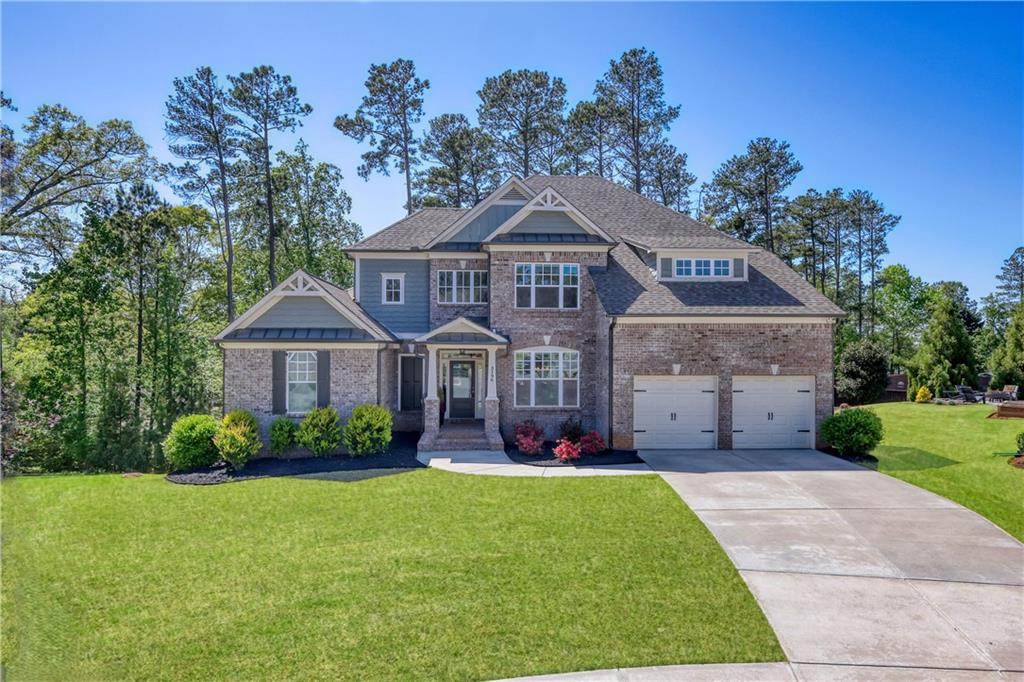 a front view of a house with a garden