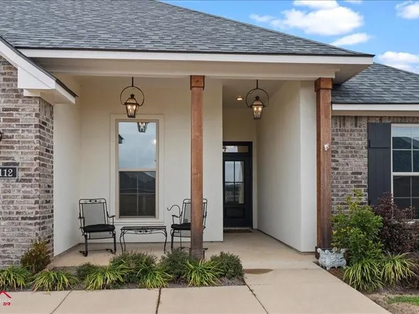 a front view of a house with outdoor seating