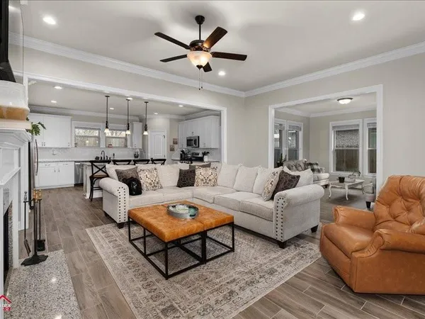 a living room with furniture a ceiling fan and a rug