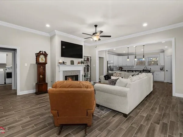 a living room with furniture a flat screen tv and a fireplace
