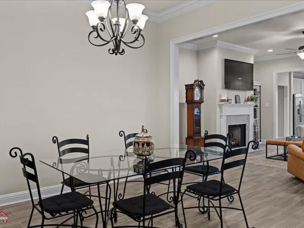 a view of a dining room with furniture and chandelier