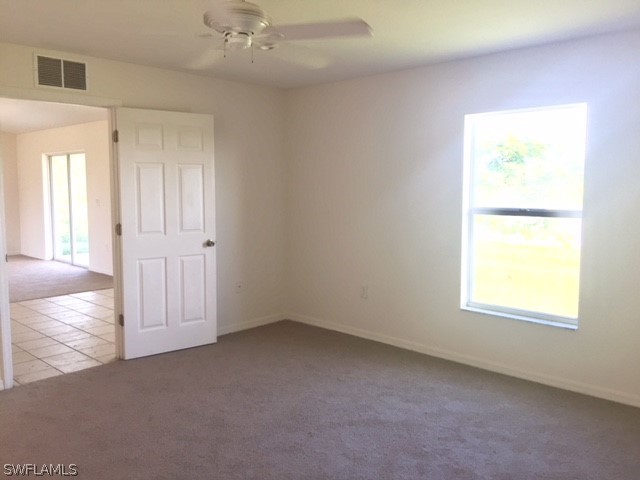 3608 13th Street Southwest Lehigh Acres, FL 33976 - Photo 5 of 11 an empty room with windows and closet