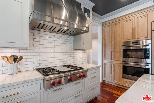 a kitchen with granite countertop stainless steel appliances and wooden cabinets