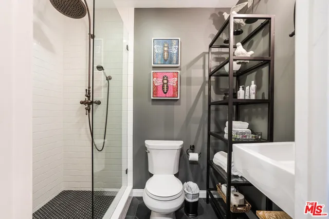 a bathroom with a toilet and a shower