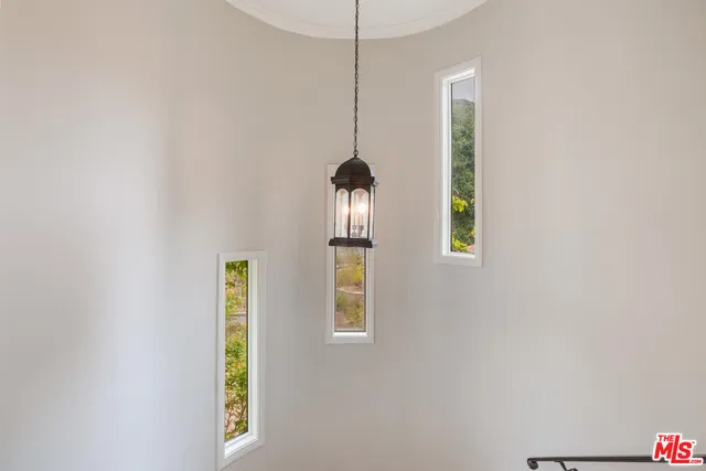 a room with window and a chandelier