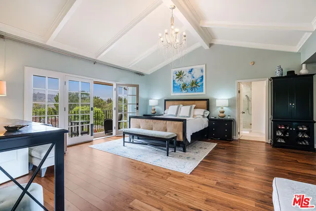 a living room with furniture a flat screen tv and a large window