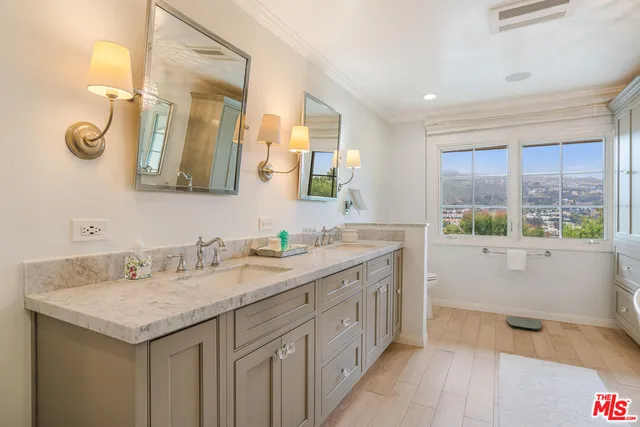 a bathroom with a granite countertop sink mirror and double