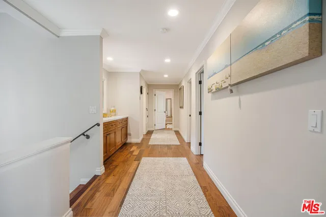 a view of gallery with wooden floor