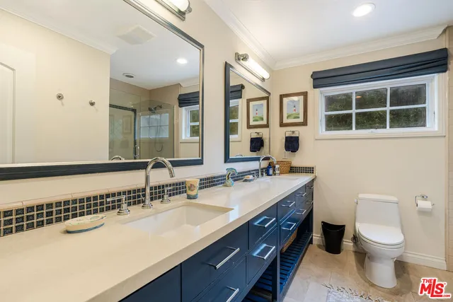 a bathroom with a sink double vanity and a toilet