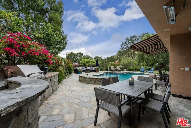 a view of a patio with table and chairs and potted plants