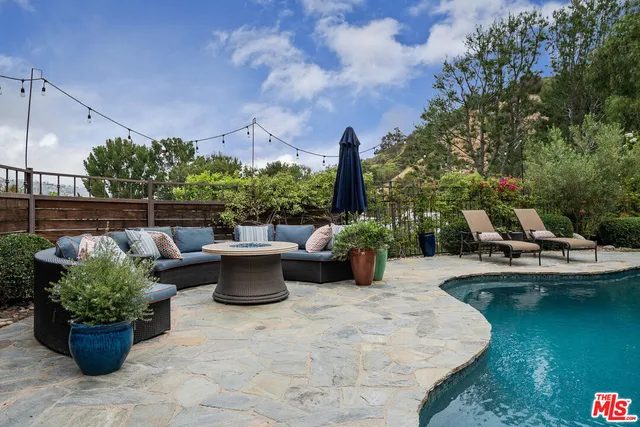 a view of a patio with couches and potted plants