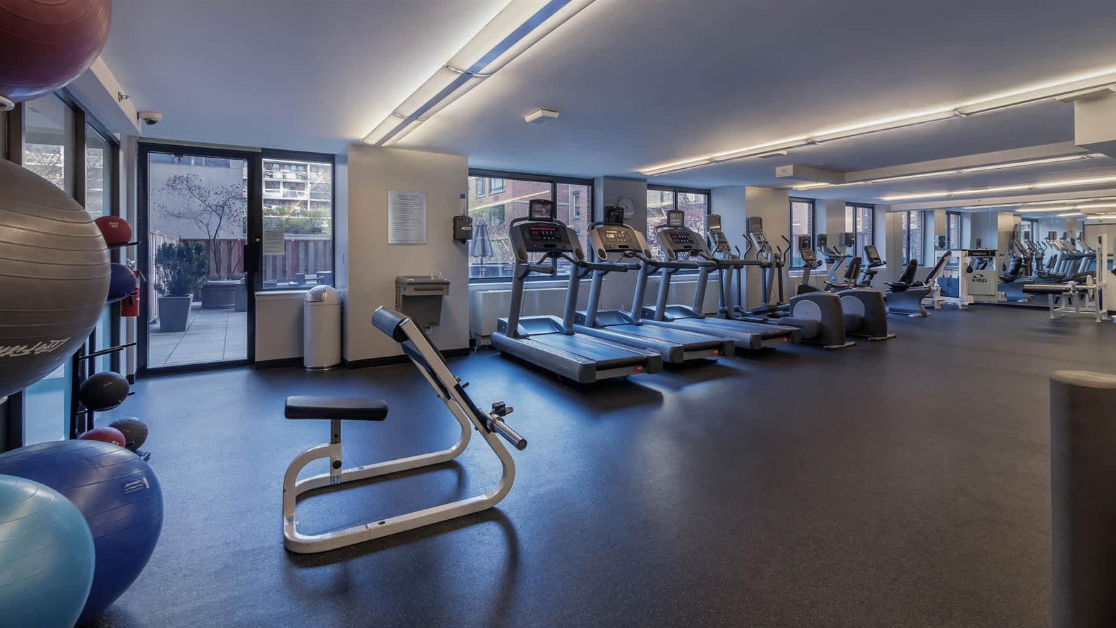 505 West 54th Street, Unit 915 Manhattan, NY 10019 - Photo 4 of 10 a view of a room with gym equipment
