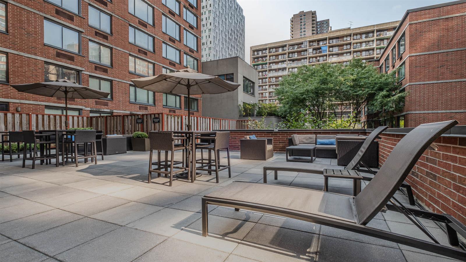 505 West 54th Street, Unit 915 Manhattan, NY 10019 - Photo 10 of 10 a view of a patio with couches table and chairs and potted plants