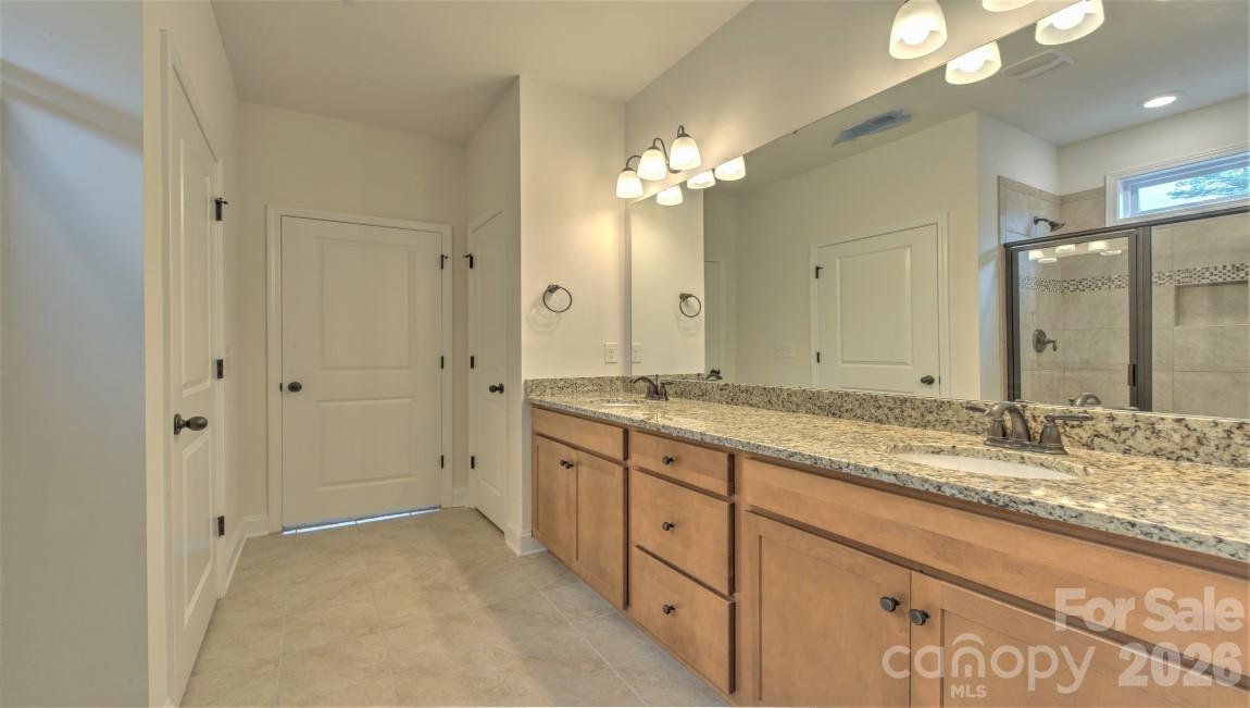 649 River Btm Road Fletcher, NC 28732 - Photo 28 of 40 a bathroom with a granite countertop double vanity sink shower and a mirror