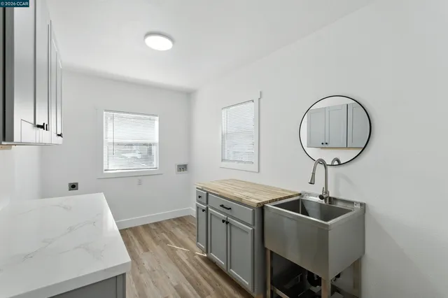 a spacious bathroom with a double vanity sink a mirror and a bathtub
