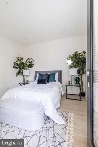 a bedroom with a bed and a potted plant