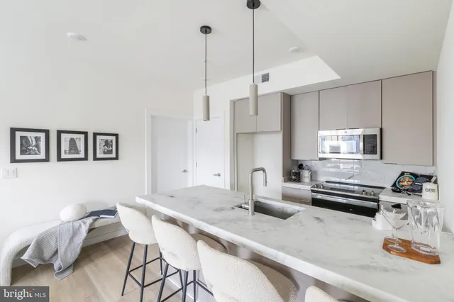 a kitchen with stainless steel appliances kitchen island granite countertop a sink and cabinets