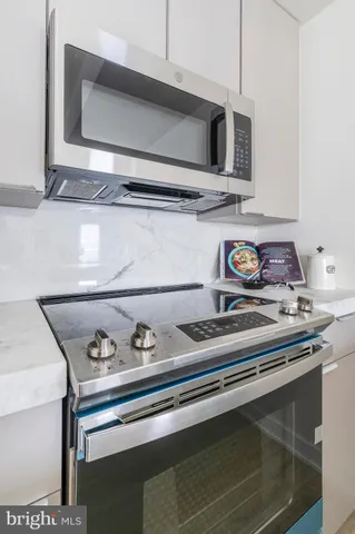 a stove top oven sitting inside of a kitchen
