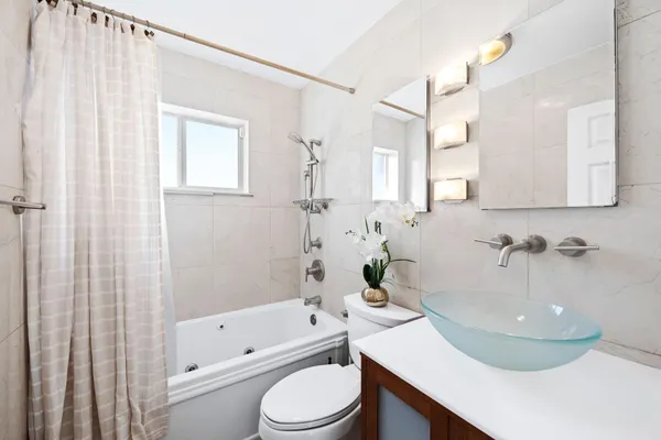 a bathroom with a sink a toilet and bathtub