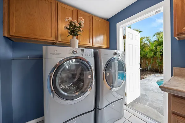 a utility room with sink dryer and washer