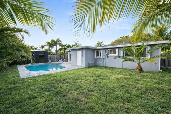 a view of a house with a yard and sitting area