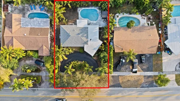 an aerial view of a house with a yard and fountain