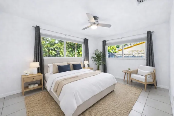 a bedroom with a bed and a large window