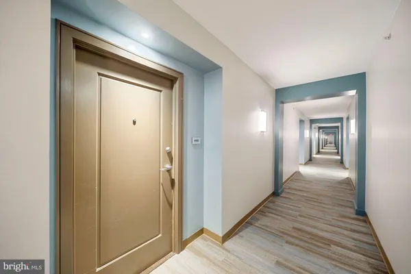 a view of hallway with wooden floor