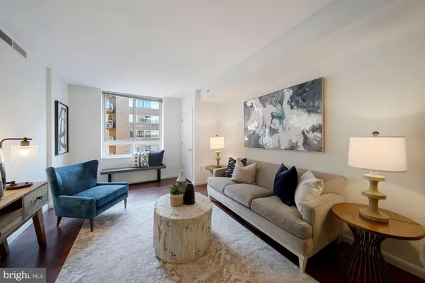 a living room with furniture and a lamp