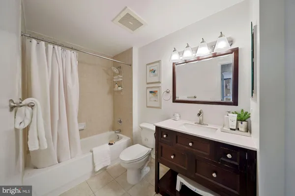 a bathroom with a double vanity sink mirror and toilet