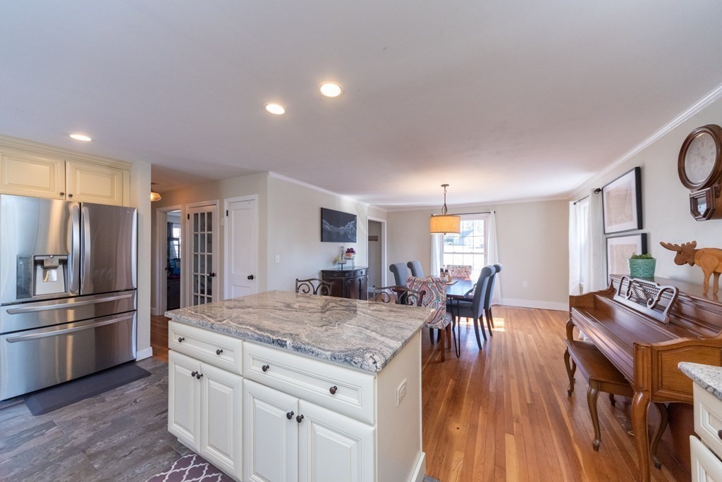 112 Elmwood Street Auburn, MA 01501 - Photo 11 of 40 a kitchen with granite countertop kitchen island wooden floor center island and stainless steel appliances