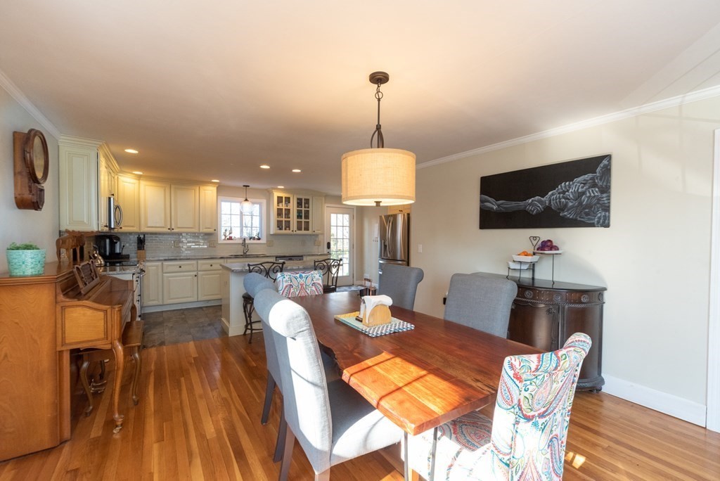 112 Elmwood Street Auburn, MA 01501 - Photo 13 of 40 a view of a dining room with furniture wooden floor and chandelier