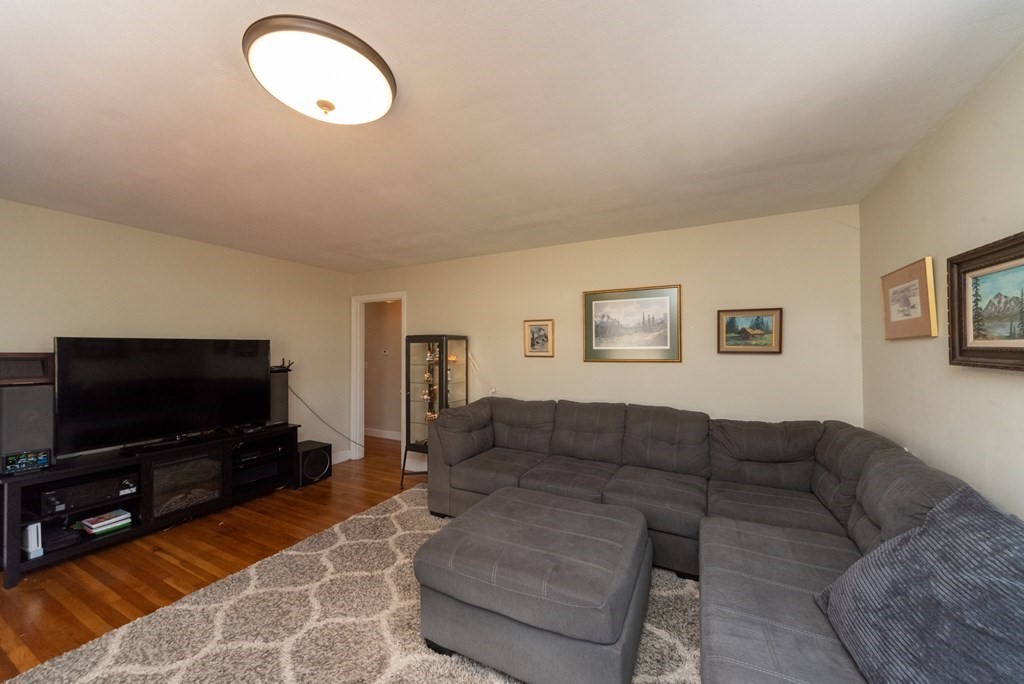112 Elmwood Street Auburn, MA 01501 - Photo 16 of 40 a living room with furniture and a flat screen tv