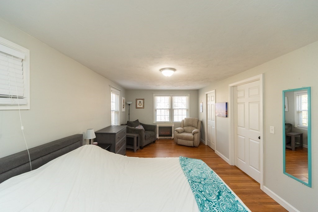 112 Elmwood Street Auburn, MA 01501 - Photo 21 of 40 a bed room with a bed and a couch