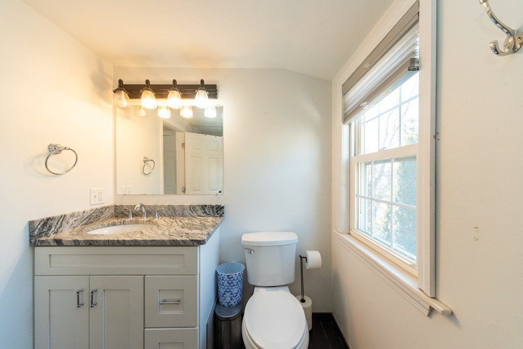112 Elmwood Street Auburn, MA 01501 - Photo 25 of 40 a bathroom with a granite countertop sink toilet and mirror