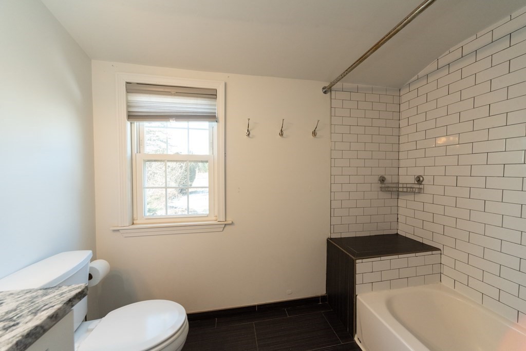 112 Elmwood Street Auburn, MA 01501 - Photo 26 of 40 a bathroom with a sink a toilet and bathtub