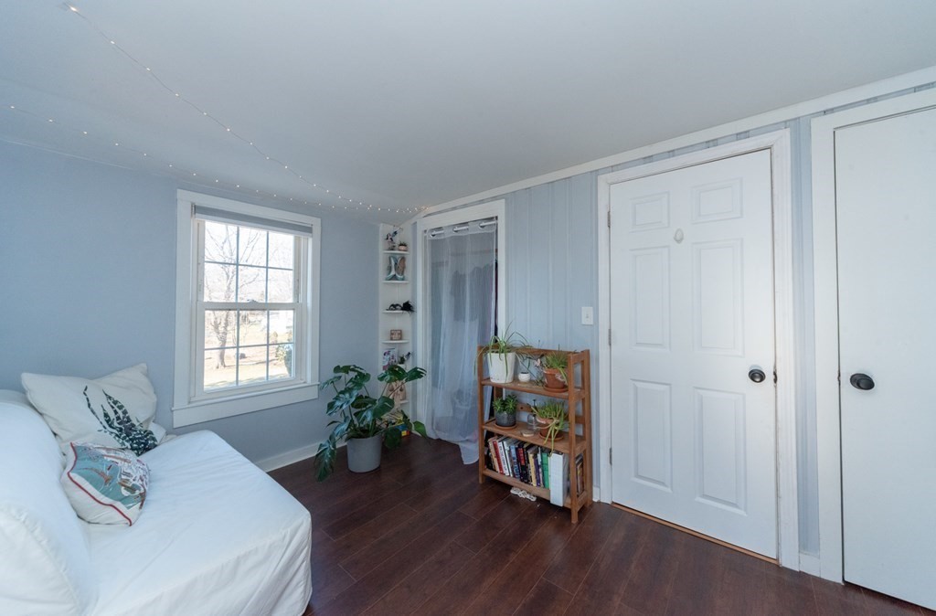 112 Elmwood Street Auburn, MA 01501 - Photo 29 of 40 a living room with furniture a large window and wooden floor